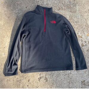 The North Face Charcoal Fleece with Red and grey quarter zip has tiny hole